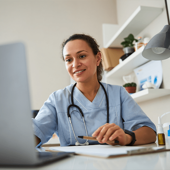 doctor smiling at laptop