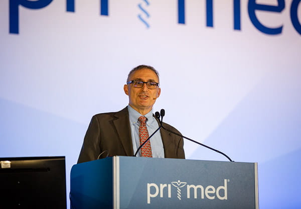 Dr. Domino speaking on stage