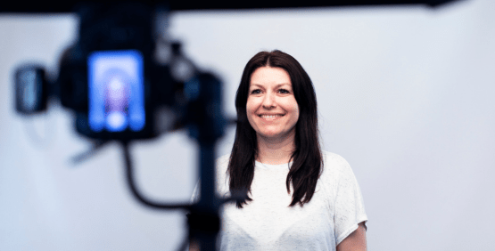 a woman in a white tee shirt is getting her headshot taken