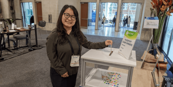 Attendee entering her passport card into a bin to win prizes
