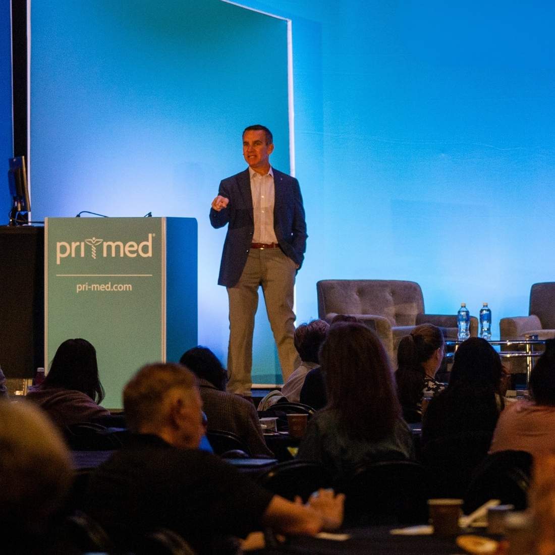 dr. vega speaking in front of a crowd