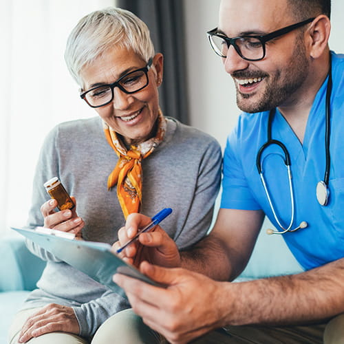 Clinician showing a patient a document on a clipboard