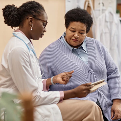 Doctor showing a patient a tablet.