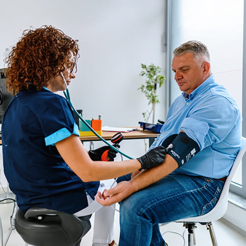 nurse taking patients blood pressure